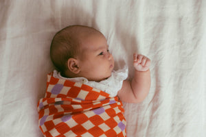 Check Mate Cherry Red with Lilac Speck | Swaddle